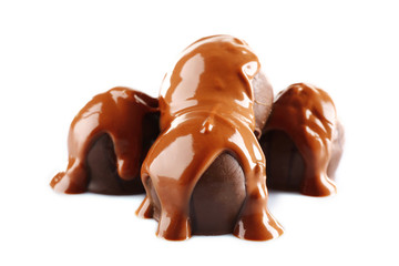 Chocolate poured on candy isolated on white