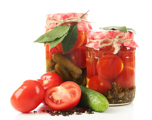 Jars of canned tomatoes and cucumbers isolated on white