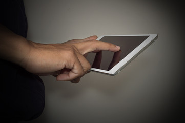 Male hands holding digital tablet touch screen