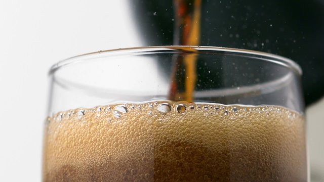 Pouring coke into glass shooting with high speed camera.