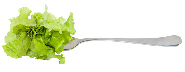 fork with impaled fresh green lettuce isolated