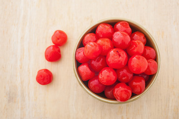 Sweet cherry in a bowl on wooden background