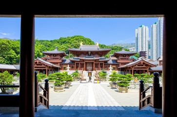 Hong Kong, the Chi Lin antique monastry and, in the background the towers of the new Kowloon quarter