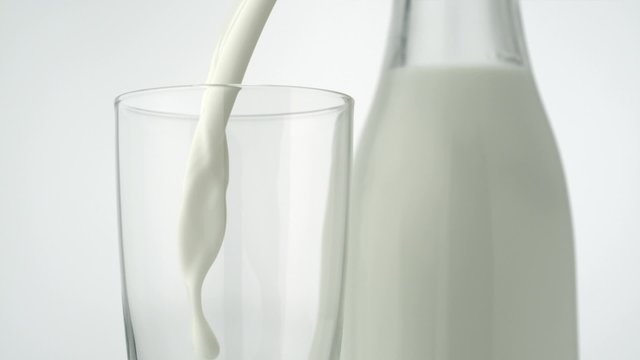 Pouring milk into glass shooting with a high speed camera. 
