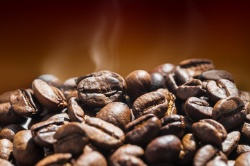 Hot coffee beans on brown background