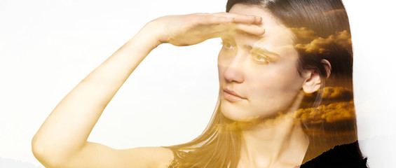 Double exposure of woman looking at horizon and sunset letterbox