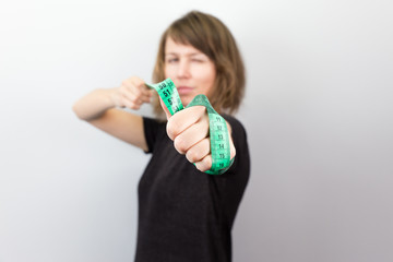 Young woman model measuring meter bow diet studio.