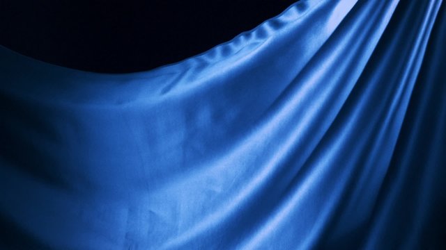 Blue silk fabric flying in the air shooting with a high speed camera. 