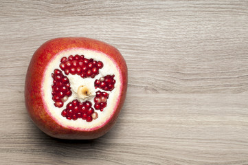 The cut-off top of the pomegranate on the table.
