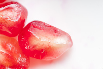 Garnet seeds on the white background.