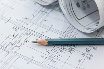 Чертежи здания  и простой карандаш.