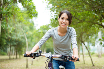 Fototapeta na wymiar Woman cycling at oudoor