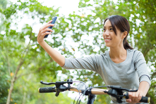 Asian Young woman like cycling and taking selfie