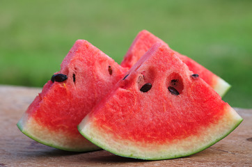 sliced watermelon on blur green background
