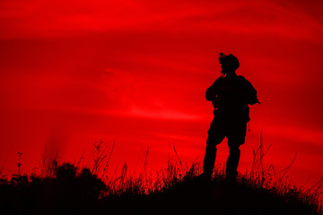 Fototapeta premium Silhouette of soldier with rifle..