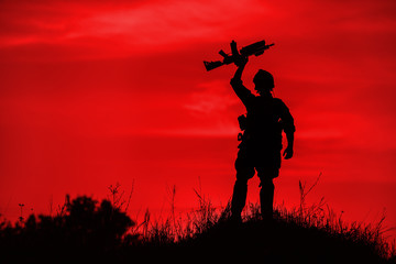 Fototapeta na wymiar Silhouette of soldier with rifle..