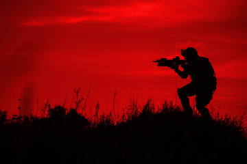 Fototapeta premium Silhouette of soldier with rifle..