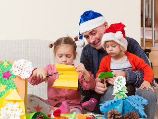 Dad with two daughters making crafts