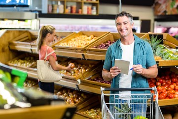 Smiling man holding the grocery list