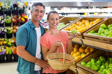 Happy couple holding an apple