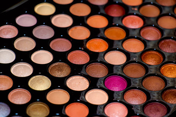 Professional palette of colored eyeshadows, close-up.