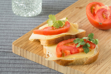 Homemade sandwich with with cheese tomatoes and coriander