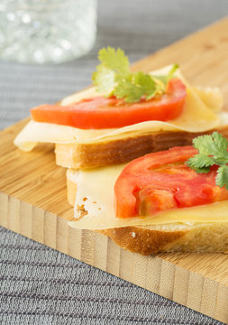 Homemade sandwich with with cheese tomatoes and coriander