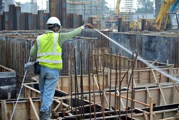 Construction workers spraying the anti termite chemical treatment 