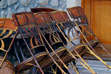 Chairs stands near the table in a street cafe