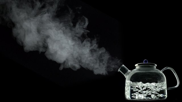 Boiling water in kettle on black background shooting with high speed camera, phantom flex.