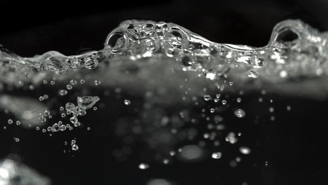 Boiling water in kettle on black background shooting with high speed camera, phantom flex.
