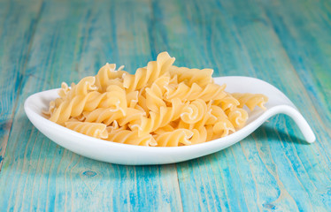 Raw spiral macaroni in plate