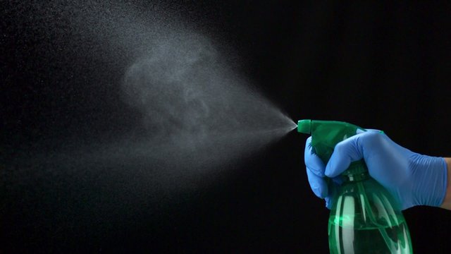 Using spraying bottle and cleaning on black background shooting with high speed camera, phantom flex.