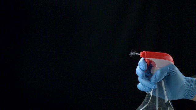 Using spraying bottle and cleaning on black background shooting with high speed camera, phantom flex.