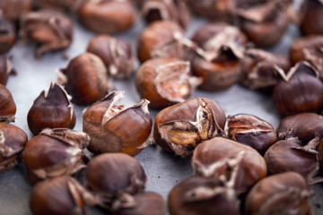 Healthy winter snack chestnuts on wooden background, selective focus