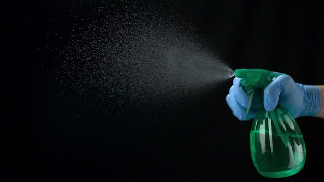 Using spraying bottle and cleaning on black background shooting with high speed camera, phantom flex.