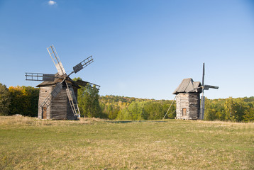 Fototapeta na wymiar Windmills standing in the field against the blue sky