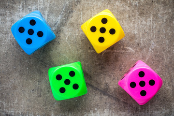 Four color dices on canvas background