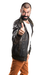 Fototapeta premium Man wearing a leather jacket with thumb up