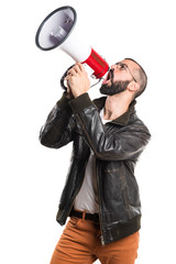 Man wearing a leather jacket shouting by megaphone