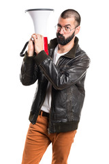 Man wearing a leather jacket shouting by megaphone