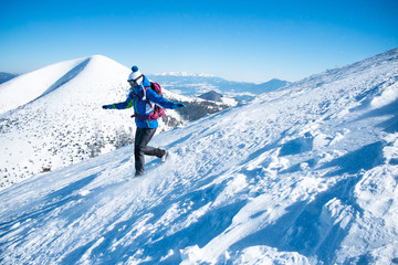 woman descending from snowy mountains