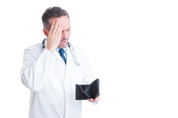 Upset medic or doctor checking empty wallet