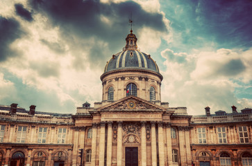 Fototapeta premium Institut de France in Paris. Famous cupola, dome of the building against clouds.