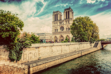 Fototapeta na wymiar Notre Dame Cathedral in Paris, France and the Seine river. Vintage