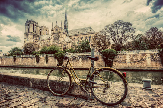 Retro bike next to Notre Dame Cathedral in Paris, France. Vintage