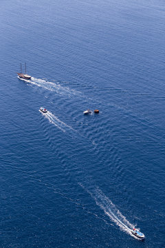 Yacht navigates into beautiful blue water near Santorini island, © ververidis