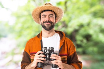Tourist with binoculars over white background