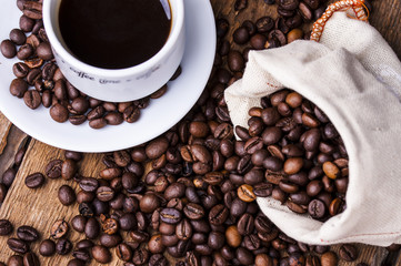 Coffee cup and coffee beans on table