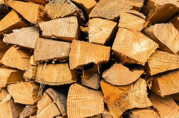 Fototapeta premium Ecological wood, wooden pattern texture - Stack of wood abstract photo of a pile of natural wooden trunks for construction buildings or fire - 